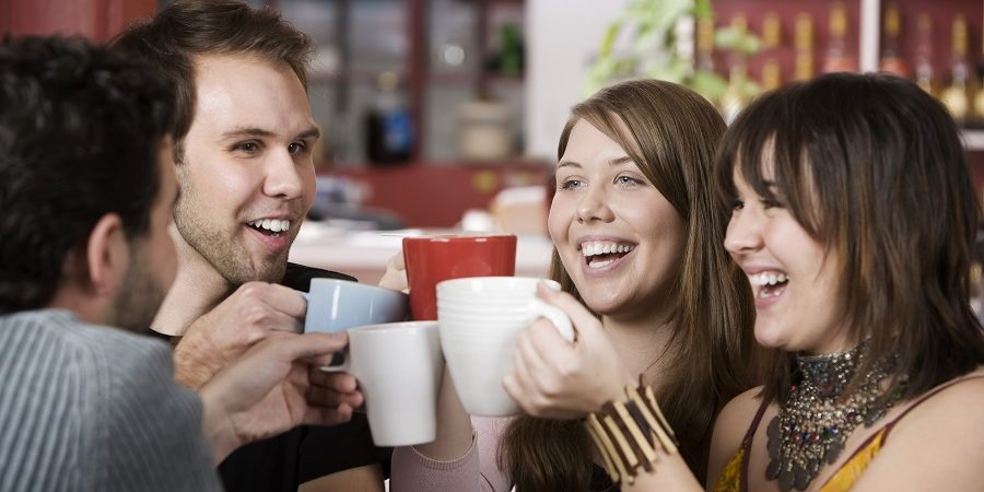 Young Friends Toasting With Coffee Cups generation z