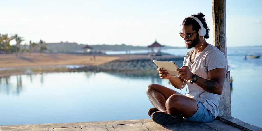 man vacationing using online restaurant management software to manage his business