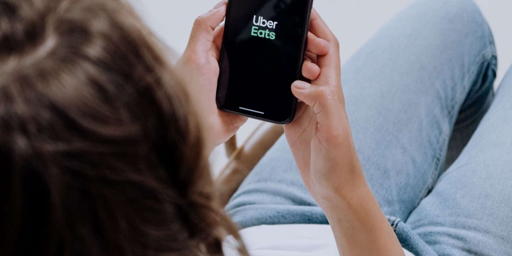 ordering-ubereats-cottonbro man ordering uber eats through delivery apps on phone