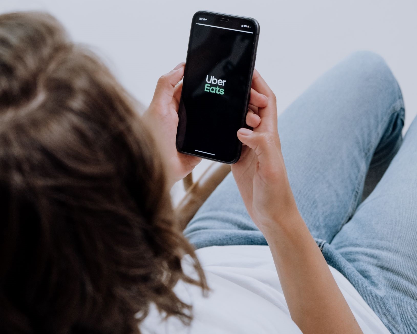 man ordering uber eats through delivery apps on phone