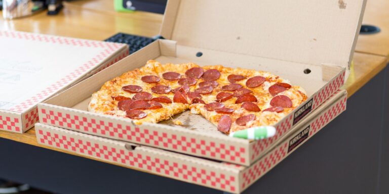 delivery pizza sitting in box at office