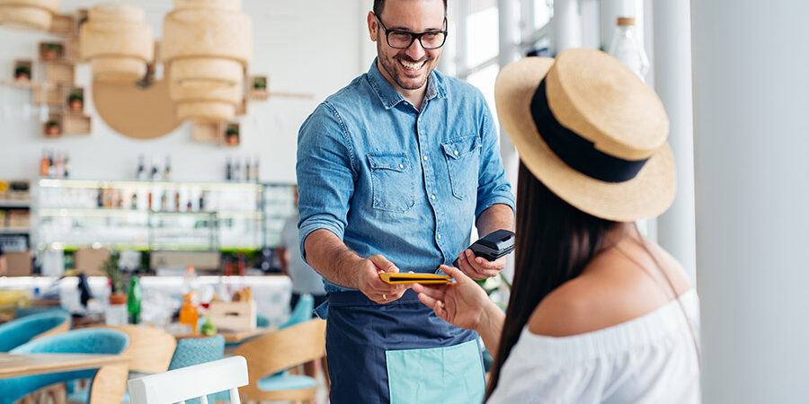 A young and attractive woman paying the bill in a restaurant