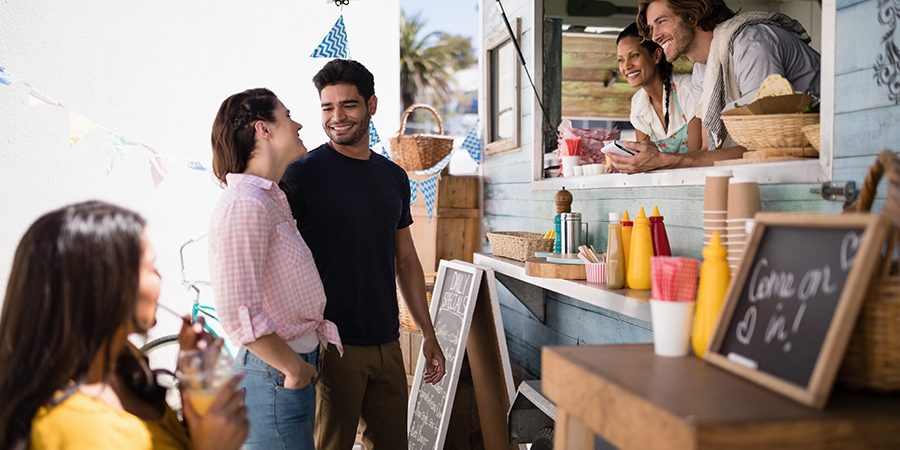 Couple interacting with each other at food truck van Couple interacting with each other at food truck van